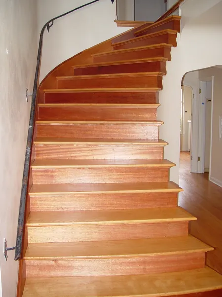 Curved staircase after refinishing the oak treads and wood risers